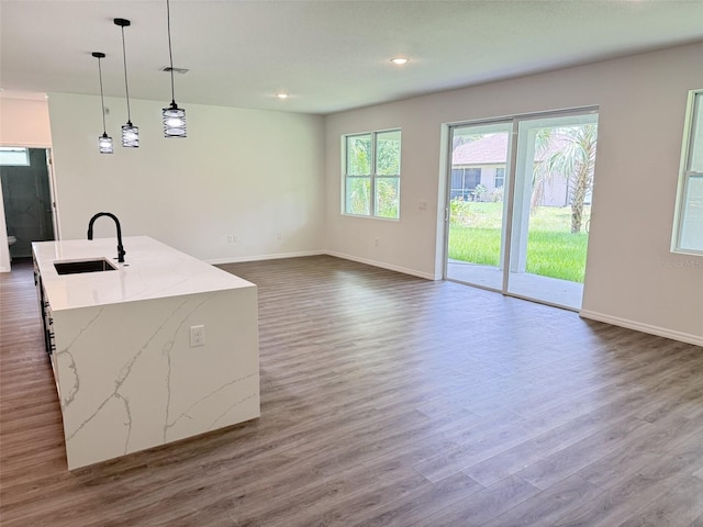 1294 Napoleon Rd, North Port, FL 34288 - unfurnished living room featuring a sink, dark wood finished floors, baseboards, and recessed lighting