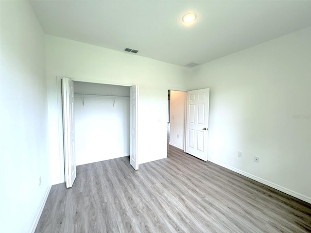 1294 Napoleon Rd, North Port, FL 34288 - unfurnished bedroom with wood finished floors, baseboards, and a closet