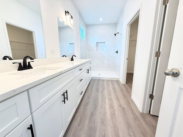 1294 Napoleon Rd, North Port, FL 34288 - bathroom with a spacious closet, a marble finish shower, double vanity, and wood finished floors