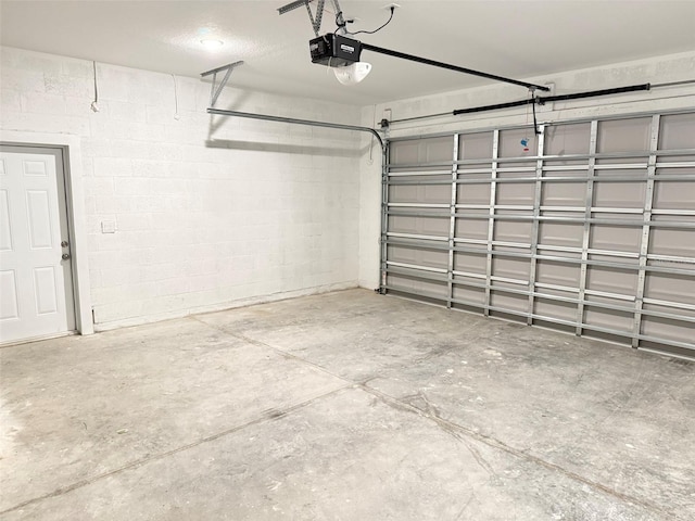 1294 Napoleon Rd, North Port, FL 34288 - garage featuring a garage door opener and concrete block wall