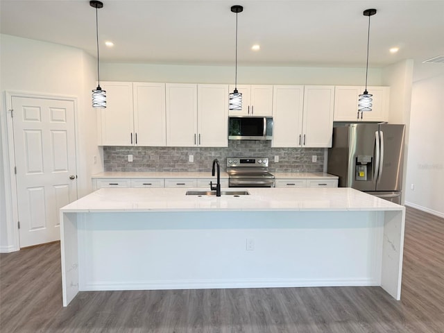 1294 Napoleon Rd, North Port, FL 34288 - kitchen featuring appliances with stainless steel finishes, a sink, wood finished floors, a kitchen island with sink, and recessed lighting