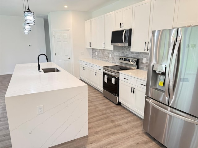 1294 Napoleon Rd, North Port, FL 34288 - kitchen with stainless steel appliances, a sink, backsplash, light wood-style flooring, and recessed lighting