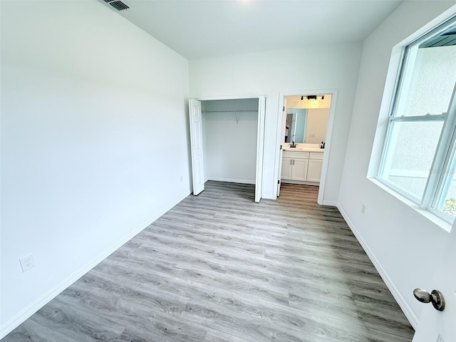 1294 Napoleon Rd, North Port, FL 34288 - unfurnished bedroom with light wood-style floors, baseboards, and a closet