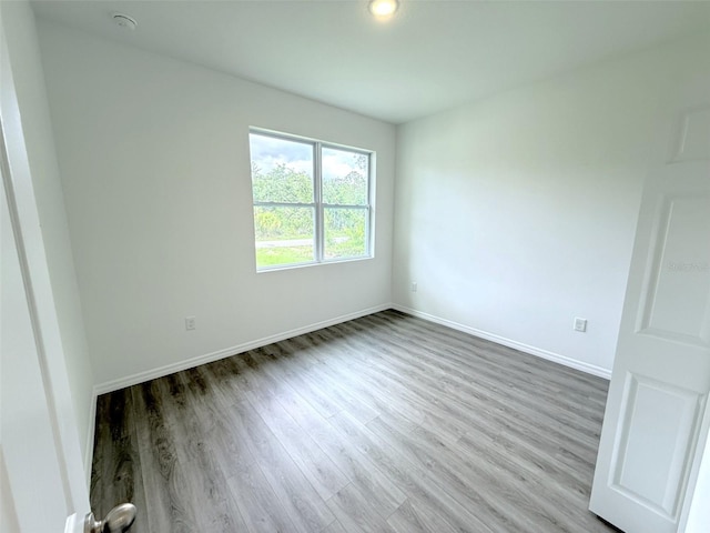 1294 Napoleon Rd, North Port, FL 34288 - empty room featuring wood finished floors, baseboards, and a smoke detector