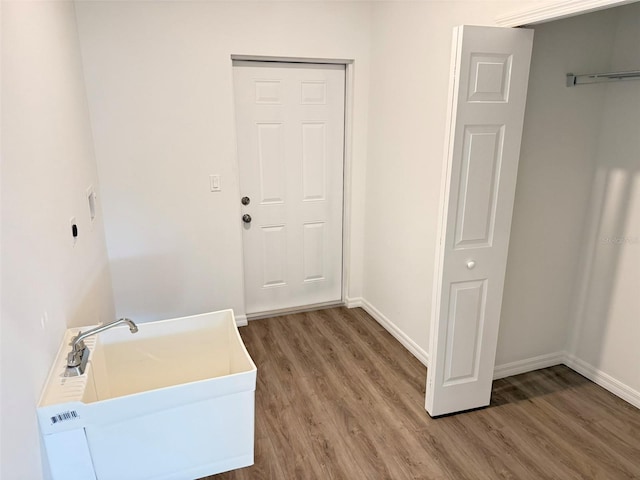 1294 Napoleon Rd, North Port, FL 34288 - washroom with a sink, wood finished floors, and baseboards