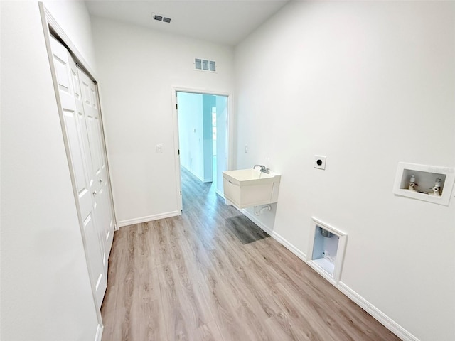 1294 Napoleon Rd, North Port, FL 34288 - washroom with electric dryer hookup, washer hookup, light wood-style flooring, and baseboards