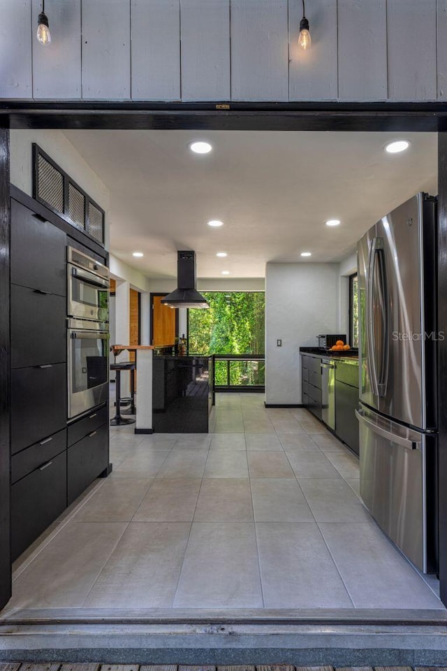 kitchen featuring extractor fan, floor to ceiling windows, light tile patterned floors, recessed lighting, and appliances with stainless steel finishes