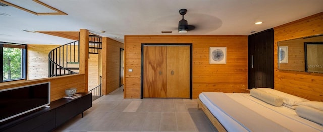 bedroom featuring wooden walls and visible vents