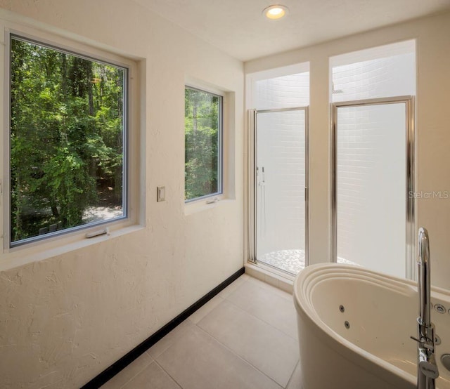 bathroom with a jetted tub, baseboards, recessed lighting, a stall shower, and tile patterned floors