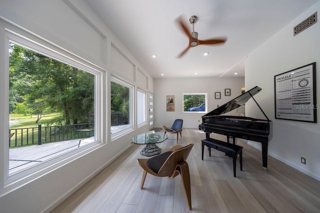 living area featuring a wealth of natural light, visible vents, recessed lighting, and light wood finished floors