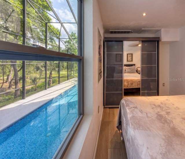 bedroom with visible vents and wood finished floors