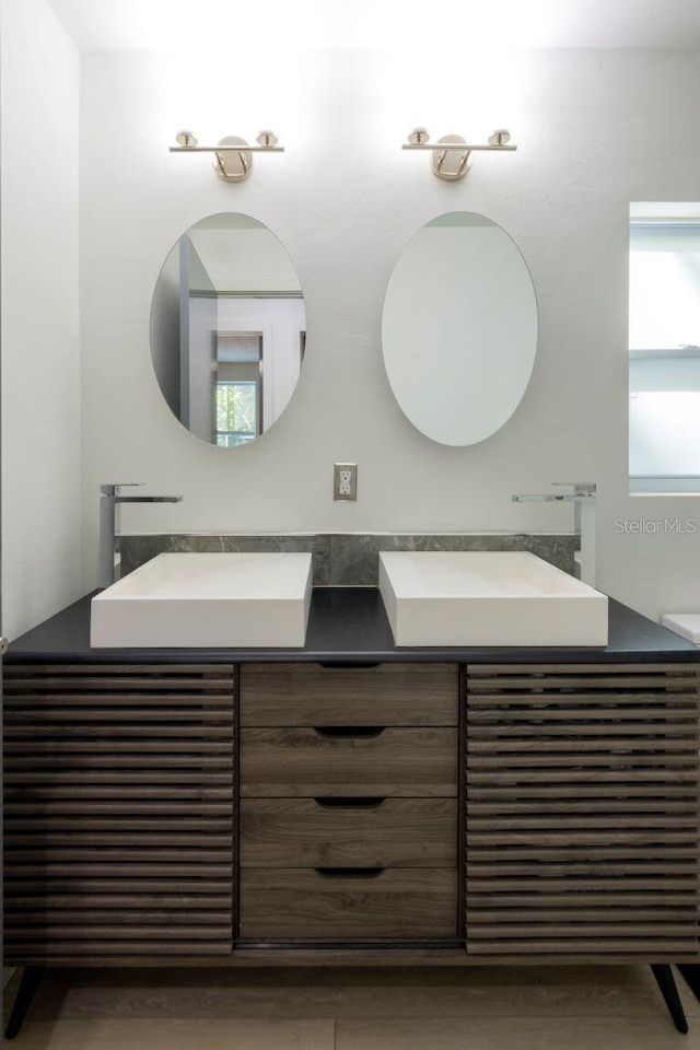 bathroom featuring a sink and double vanity