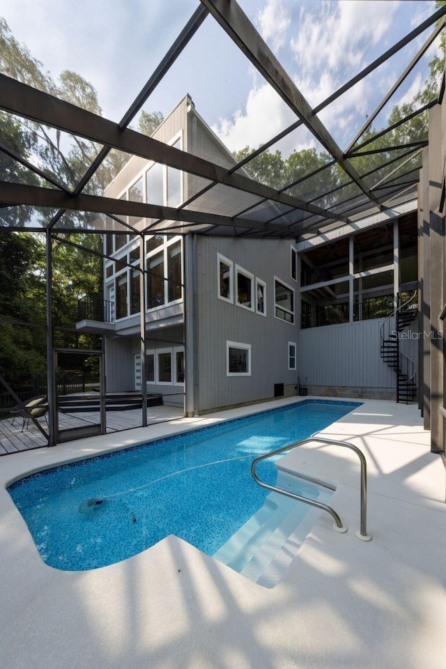 outdoor pool featuring a patio area and a lanai