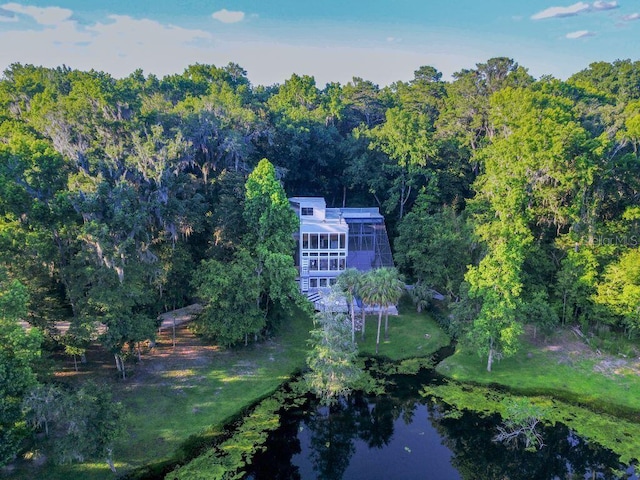 drone / aerial view with a water view and a wooded view