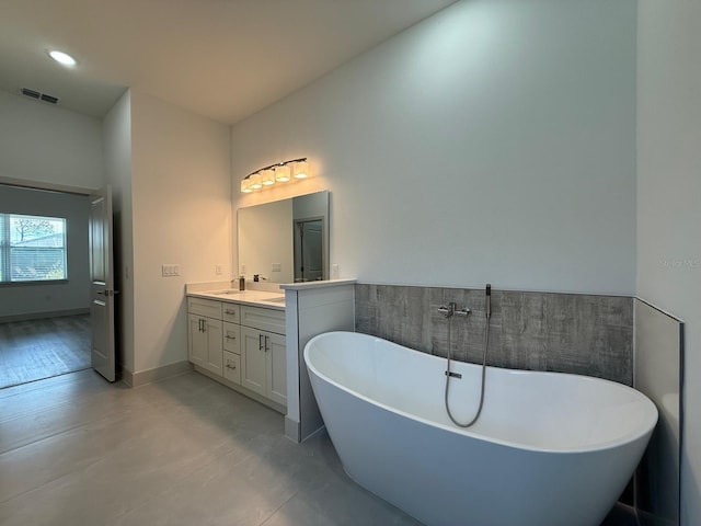 bathroom featuring a bathing tub and vanity