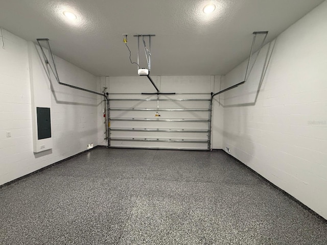 garage featuring electric panel and a garage door opener