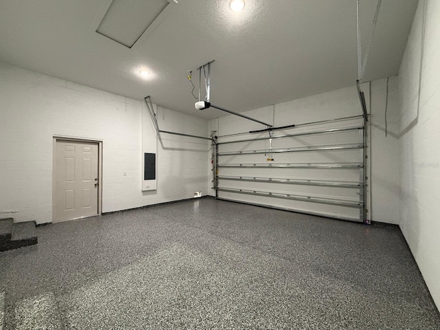 garage featuring a garage door opener and electric panel