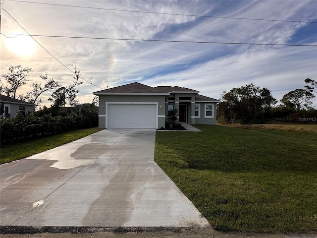 view of front of house with a yard and a garage