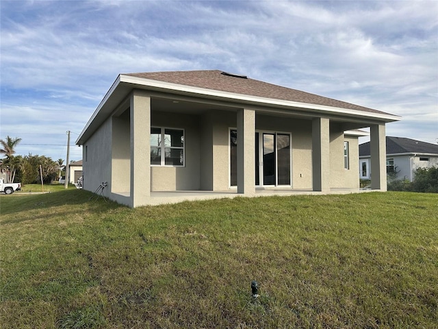 back of house with a lawn