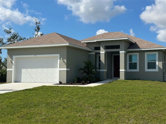 view of front of home with a garage and a front lawn