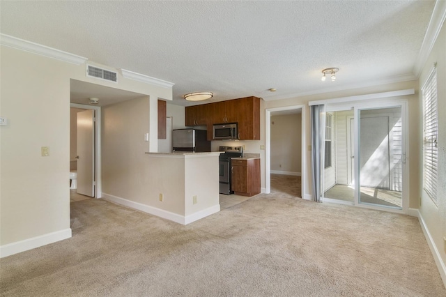 kitchen featuring light colored carpet, a textured ceiling, ornamental molding, and appliances with stainless steel finishes