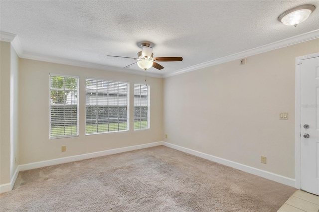 spare room with baseboards, light colored carpet, ceiling fan, a textured ceiling, and crown molding