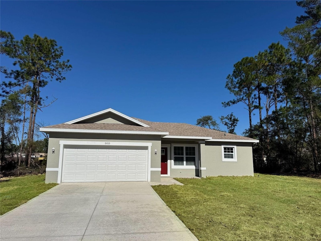 ranch-style home with a garage and a front yard