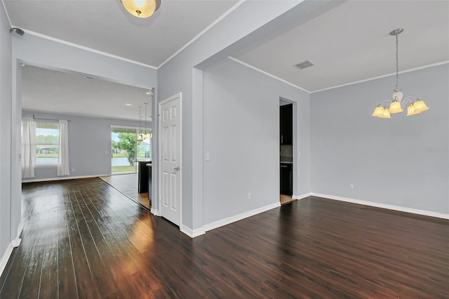 unfurnished room featuring a notable chandelier, dark hardwood / wood-style flooring, and crown molding