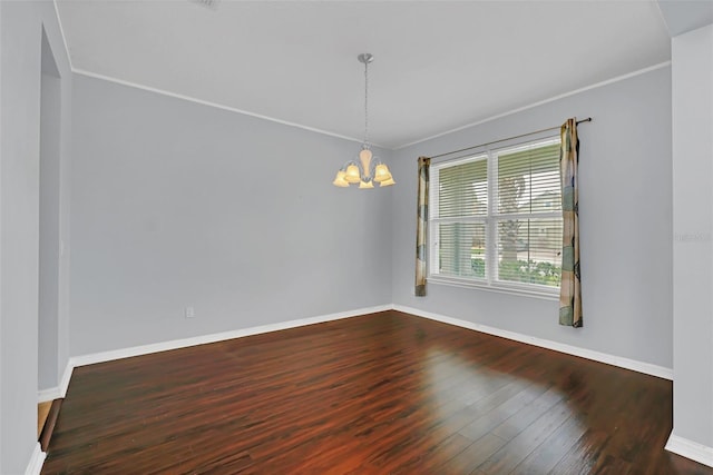 unfurnished room with a chandelier, dark hardwood / wood-style floors, and crown molding