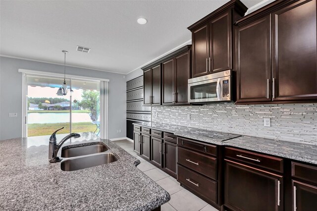 kitchen with crown molding, sink, decorative backsplash, light tile patterned flooring, and light stone counters