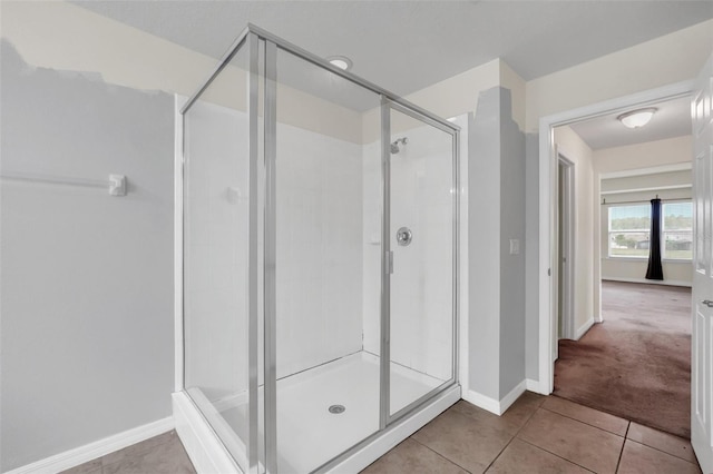 bathroom featuring tile patterned floors and a shower with door