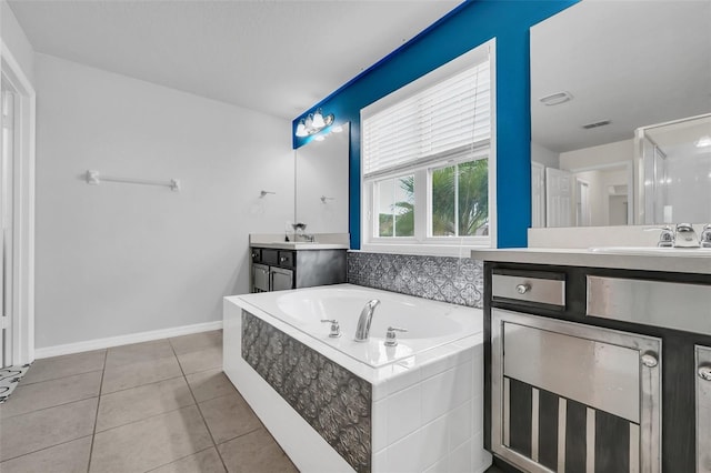 bathroom with vanity, tile patterned floors, and tiled tub