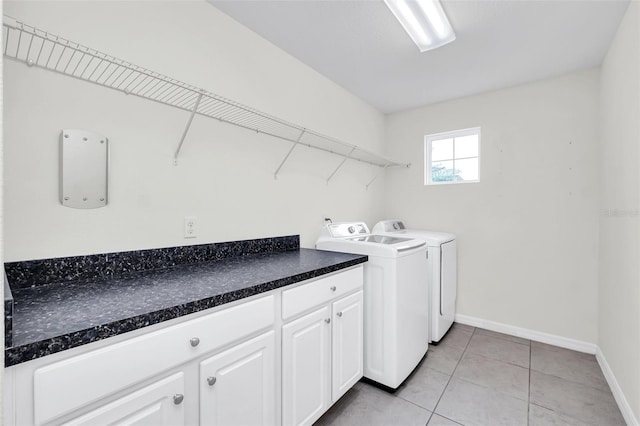 washroom with washer and clothes dryer and light tile patterned floors