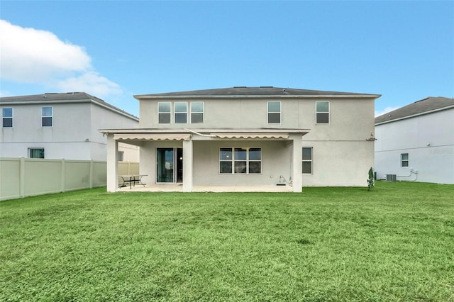 rear view of house featuring central air condition unit, a patio area, and a yard