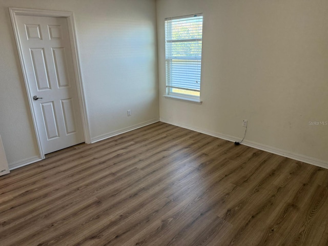 empty room with dark wood-type flooring