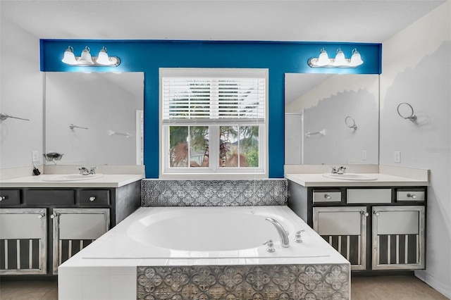 bathroom featuring vanity, tile patterned floors, and tiled tub