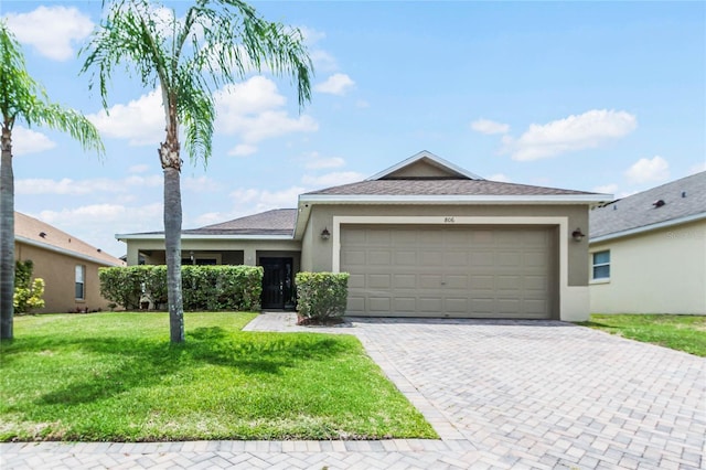 view of front facade with a garage and a front yard