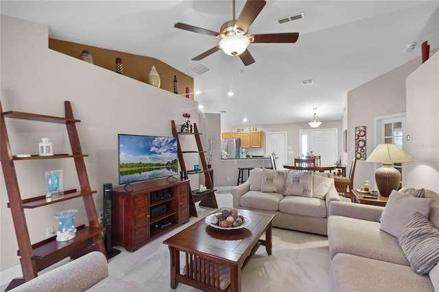 living room with ceiling fan and vaulted ceiling