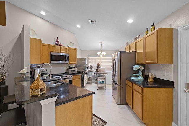 kitchen with a kitchen bar, kitchen peninsula, appliances with stainless steel finishes, and lofted ceiling