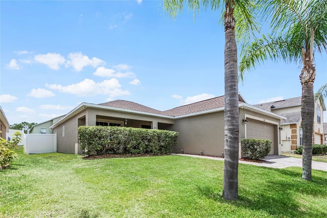 ranch-style house featuring a garage and a front lawn