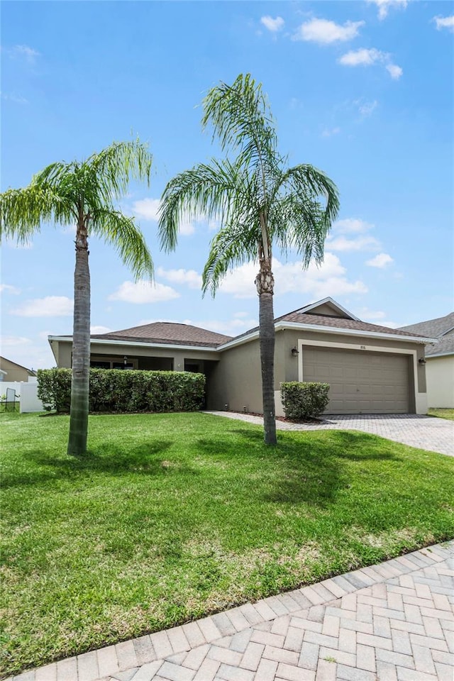 ranch-style home featuring a front lawn and a garage