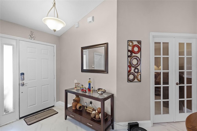 entrance foyer featuring vaulted ceiling and french doors