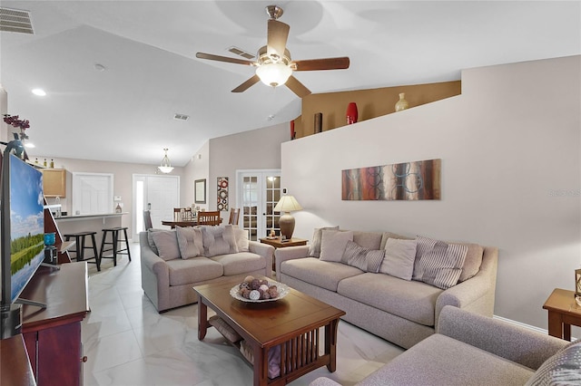 living room featuring lofted ceiling, french doors, and ceiling fan