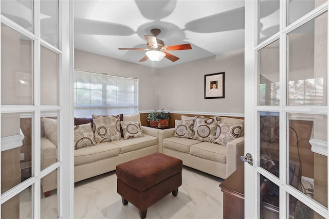 living room featuring french doors and ceiling fan