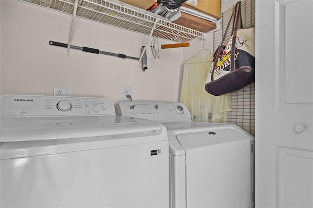 clothes washing area with separate washer and dryer