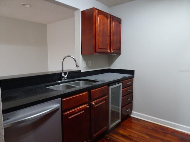 kitchen featuring dishwasher, sink, wine cooler, dark hardwood / wood-style floors, and dark stone countertops