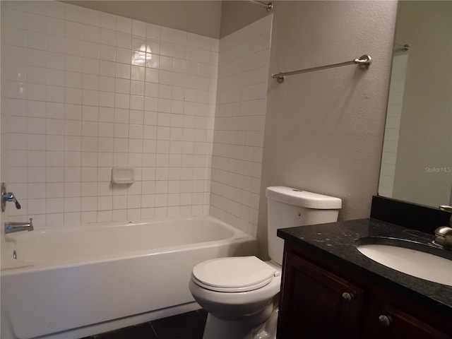 full bathroom featuring tile patterned floors, vanity, toilet, and tiled shower / bath