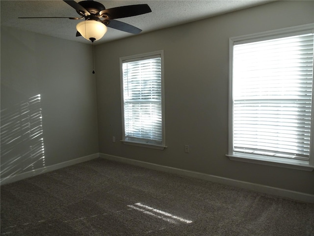 unfurnished room with carpet flooring, ceiling fan, and a textured ceiling