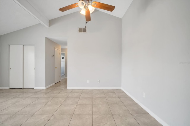 tiled empty room featuring lofted ceiling with beams and ceiling fan