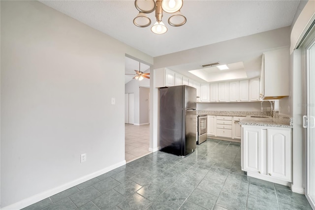 kitchen featuring stainless steel appliances, sink, light stone countertops, ceiling fan with notable chandelier, and white cabinets